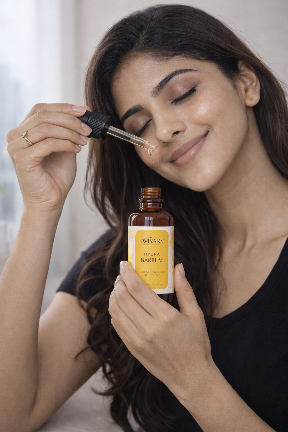 Woman applying a dropper of a skincare product to her face with a bottle labeled 'Barreux' in the other hand.