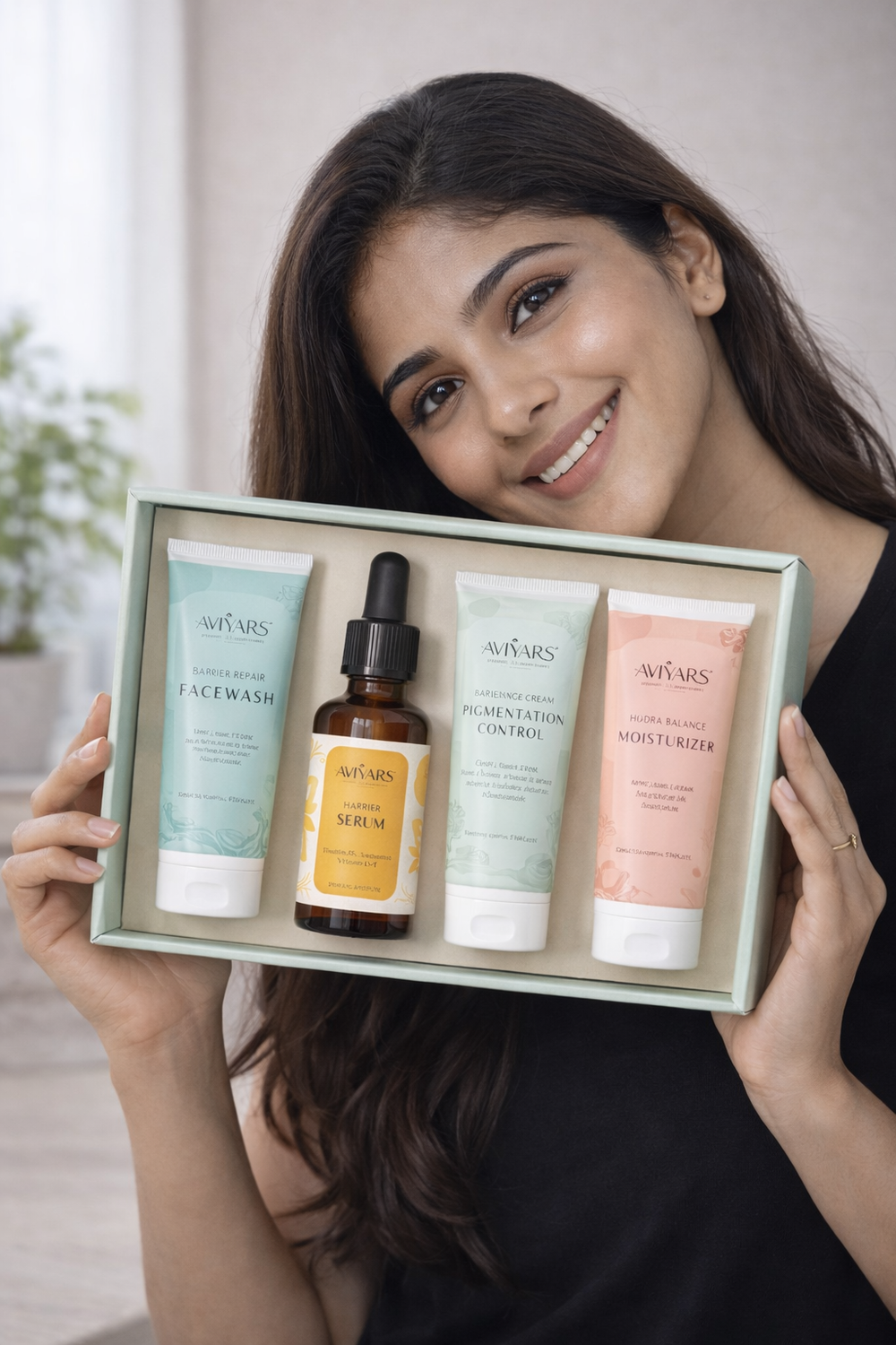 Woman holding a set of Ne'vears skincare products in a box.